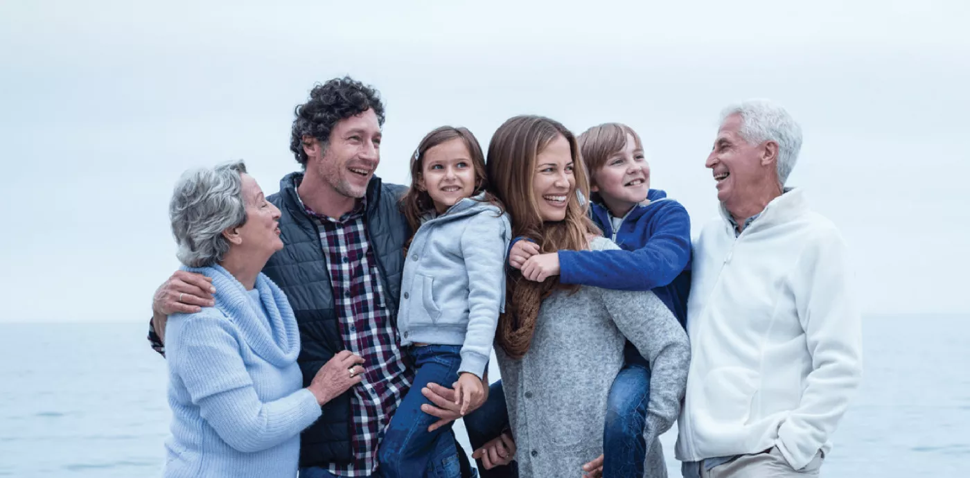 multigenerational family on beach smiling