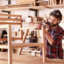Man working on a chair in a woodshop