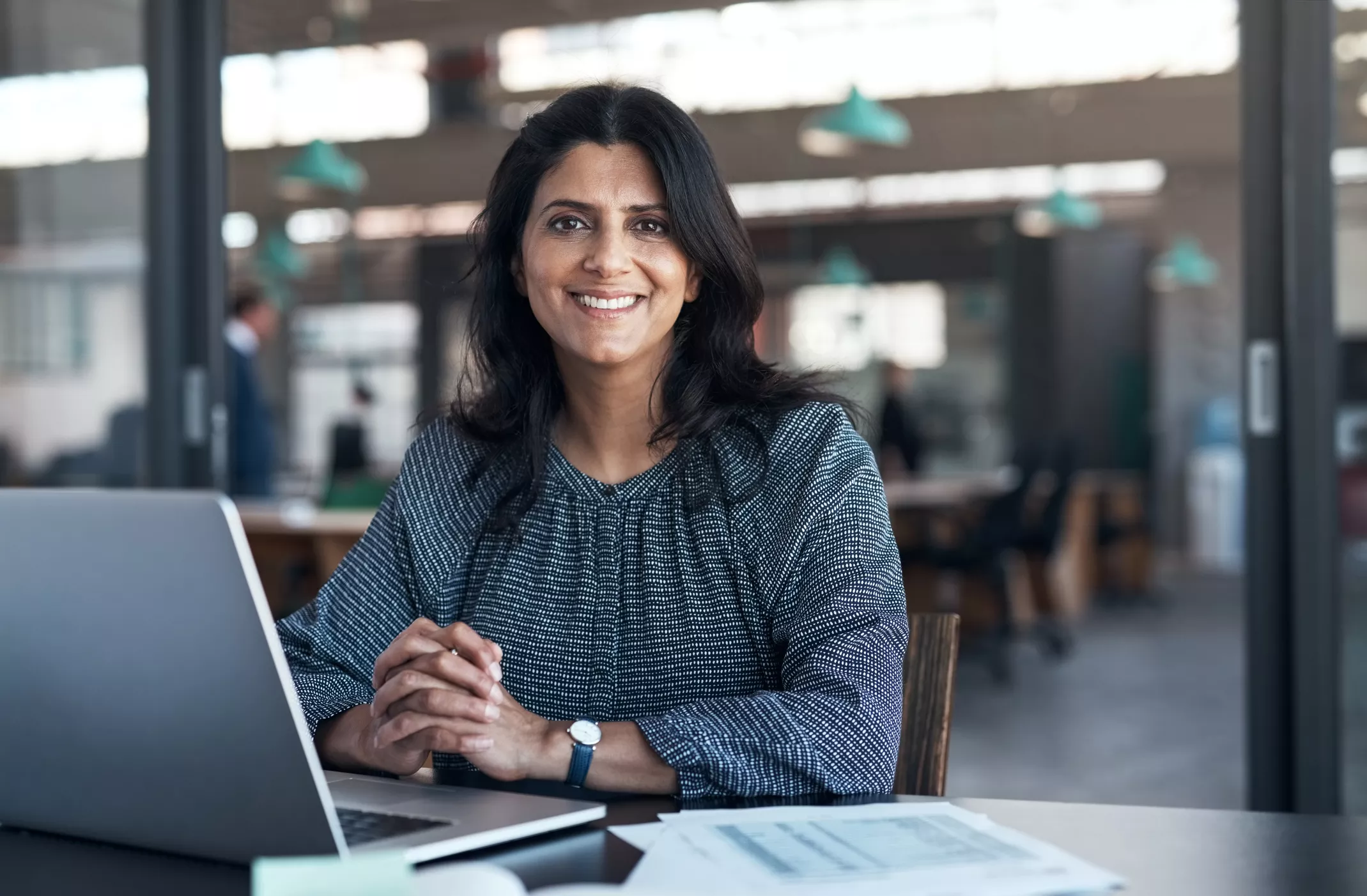 Midland Financial Advisor smiling at camera while sitting in front of computer